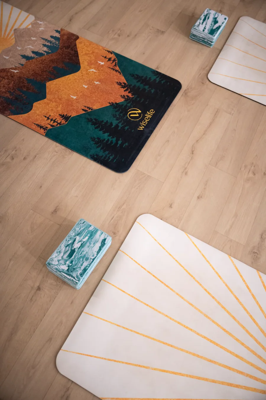 Yoga mats and blocks laid out on the studio floor at URWAY